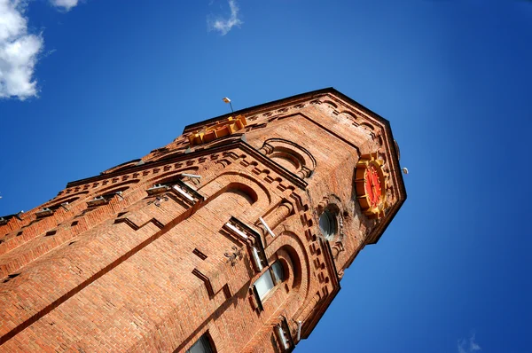 Brick tower on a background blue sky