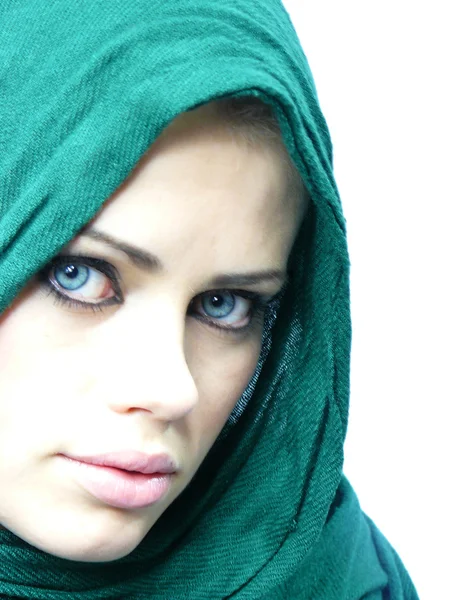 Blue-eyed woman in a green linen cape