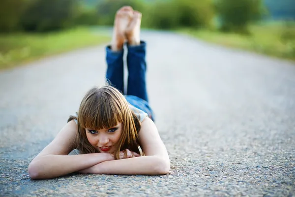 Barefoot girl on road by Alena Ozerova Stock Photo Editorial Use Only