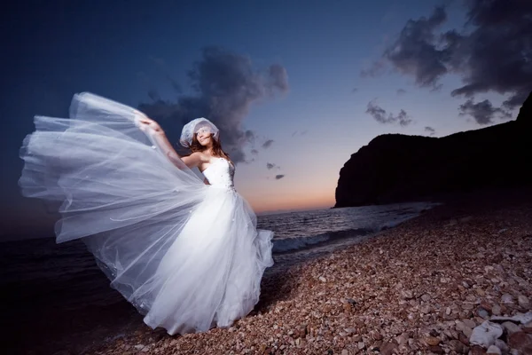 Bride on sunset beach