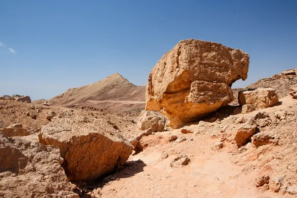 Weathered orange rocks in stone desert