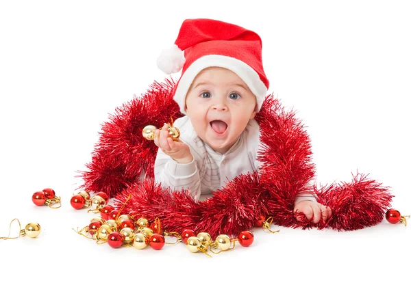 Little boy wearing a Santa hat and playi