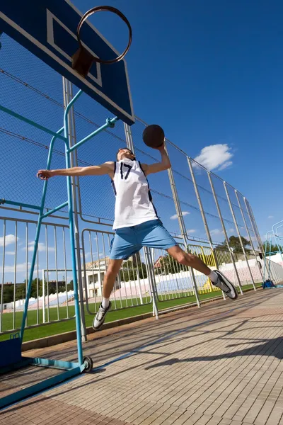 Basketball player is aiming the basket