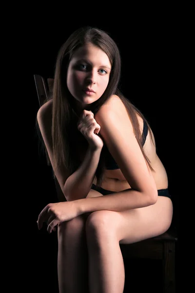 Undressed girl sit in dark by Vasiliy Koval Stock Photo Editorial Use Only