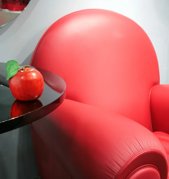 Red leather chair and apple