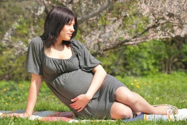 Beautiful pregnant woman in garden