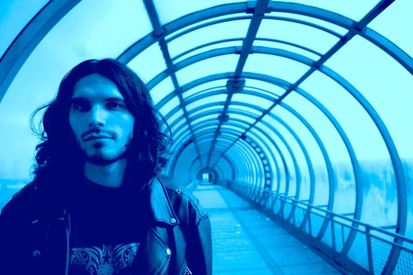 Long-haired men in blue tunnel