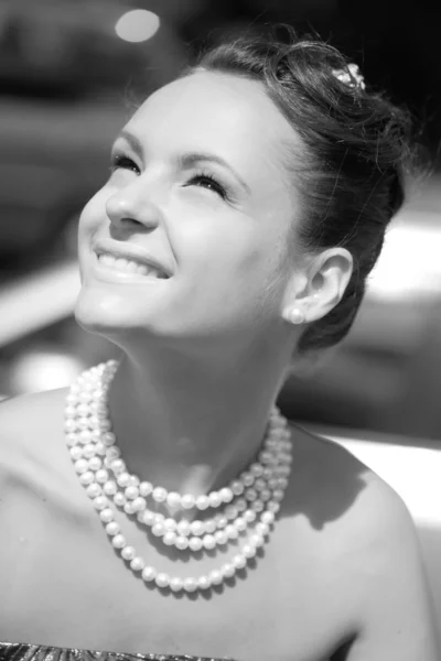 Smiling girl with pearl necklace