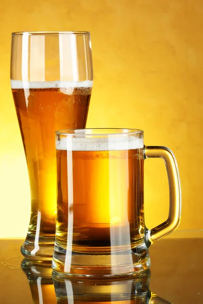 Glass and mug of beer