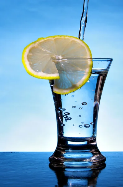 Alcoholic beverage with lemon slice