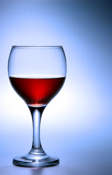 Glass of red wine over blue