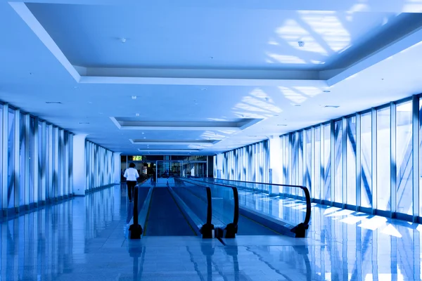 Person move in blue corridor