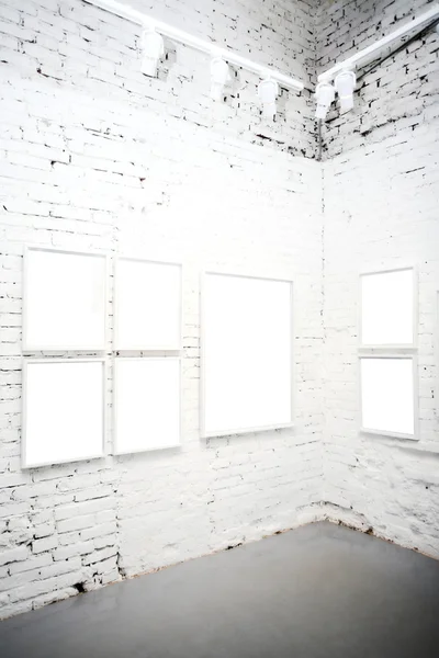 Brick wall in museum with frames
