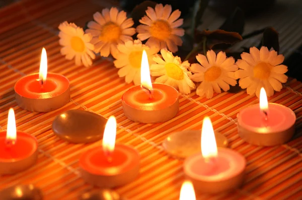 Candles, flowers and pebbles