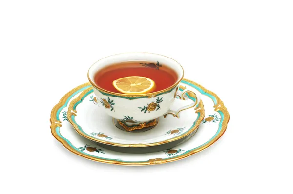 Tea with lemon and saucers isolated