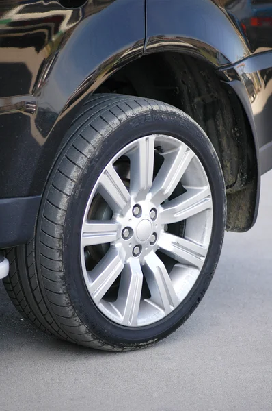 Car tyre of a shiny black car