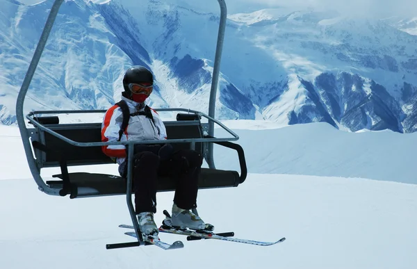 Skier on chair lift at ski resort