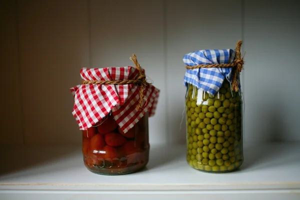 Green peas and tomatoes in the pantry — Stock Photo #1336112