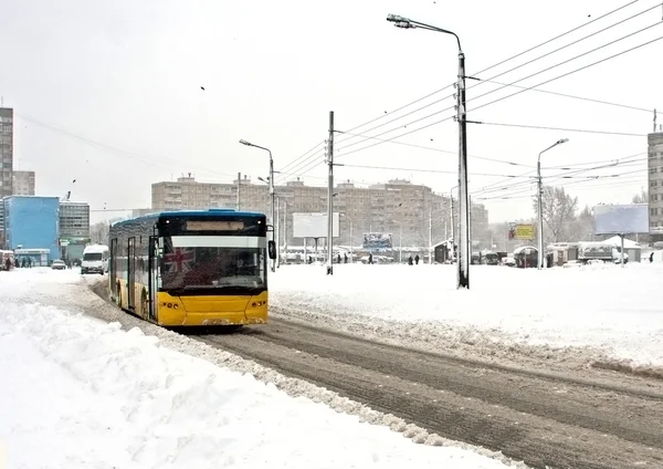 City bus moving on winter road