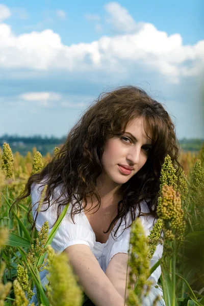 Woman in the field with wavy hair