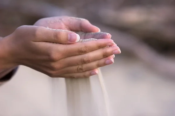 Pouring sand from hands