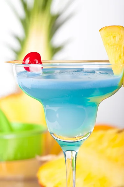 Blue alcohol cocktail with pineapple and
