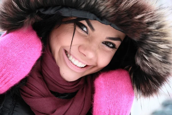Positive young girl in pink gloves by Artsiom Kireyau Stock Photo
