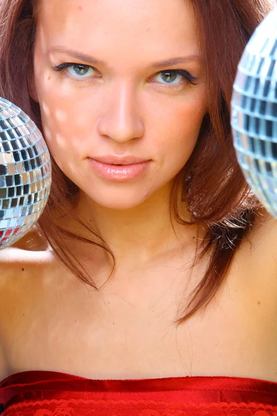 Young woman with two mirror balls