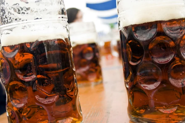 Mugs of dark beer on bavarian festival