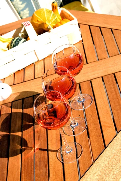 Rose wine on the wood table