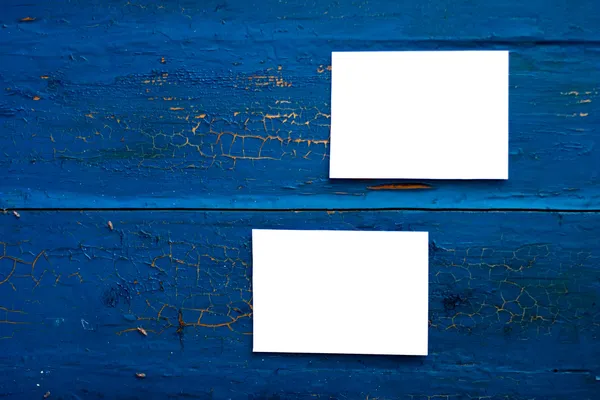 Two blank white paper cards on the blue