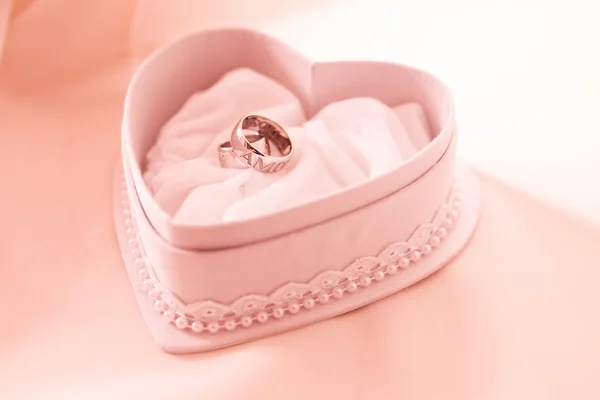 Two wedding ring in the heart shaped box by Dmytro Smaglov Stock Photo