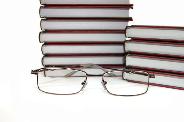 Eyeglasses laying about books