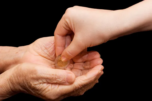 Young and old hand with a coin