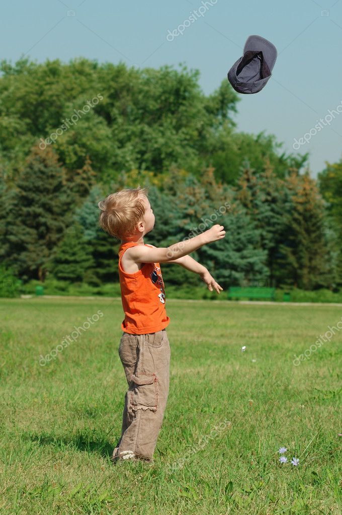 Little boy is tossing his cap — Stock Photo © pirita 2253389