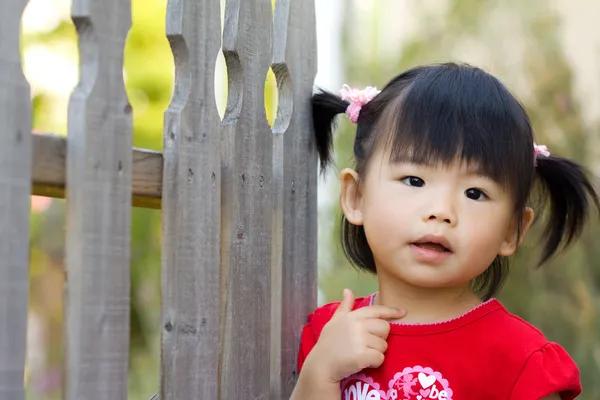 Cute little Asian Chinese girl by shirotie Stock Photo Editorial Use Only