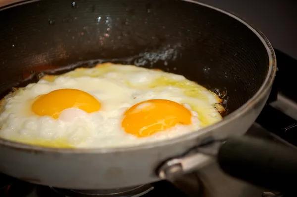 Cooking two fried eggs