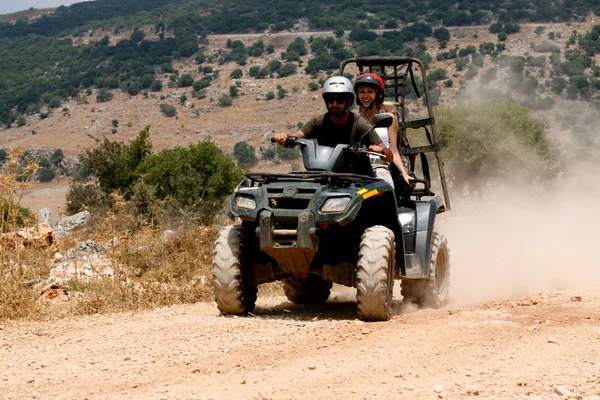 A four-wheeler ATV runs through trail
