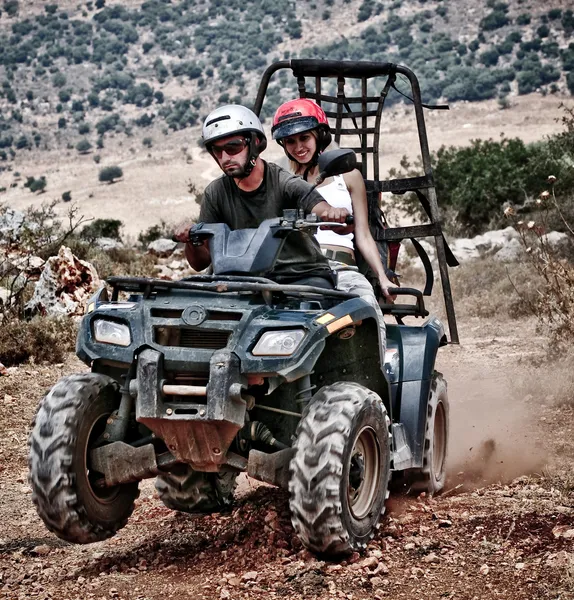 Young couple riding sand buggy