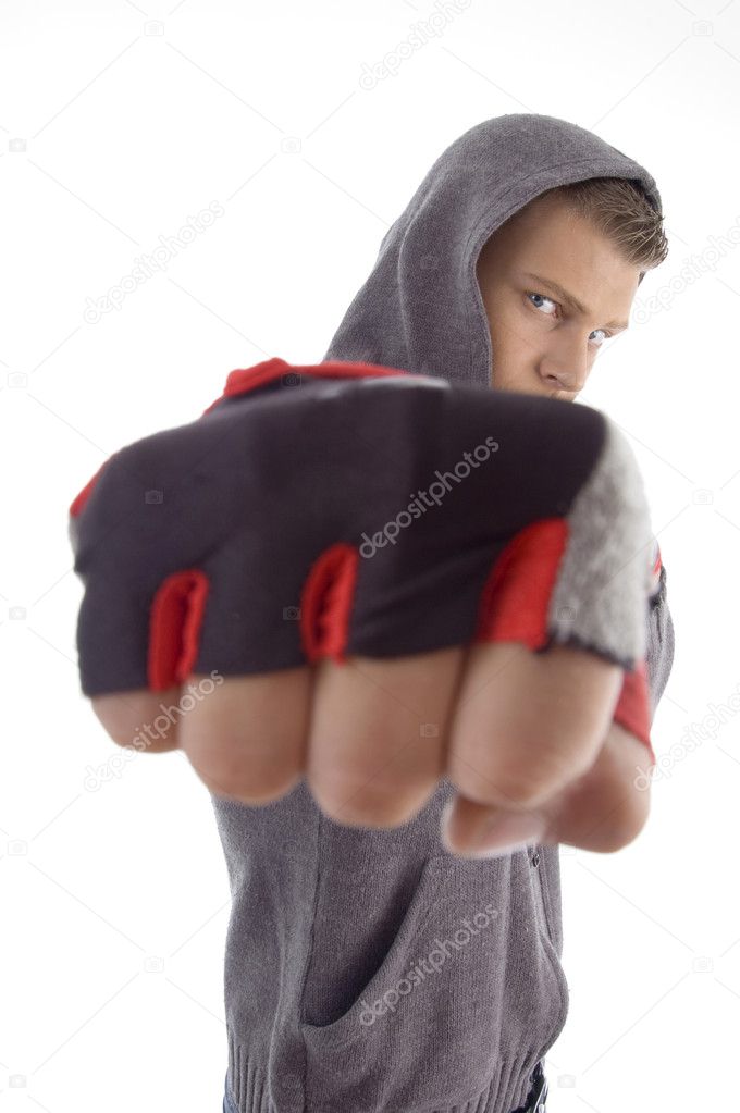 Sportive guy showing punch with exercise gloves on an isolated white