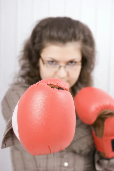 The serious girl in boxing gloves