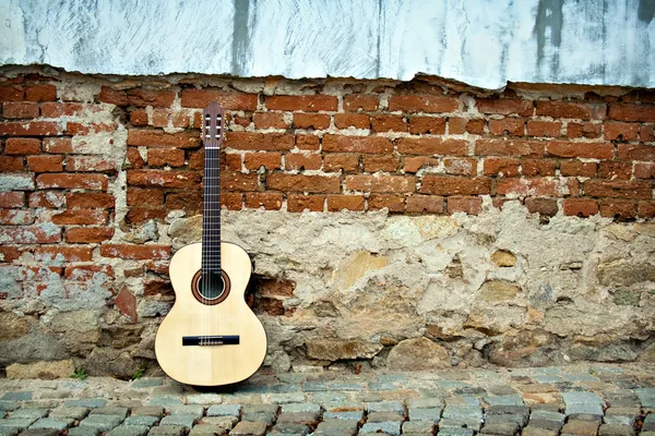 Guitar on old wall