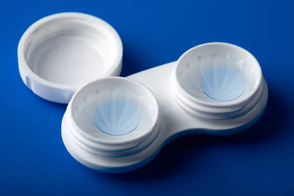 Blue contact lens in white container