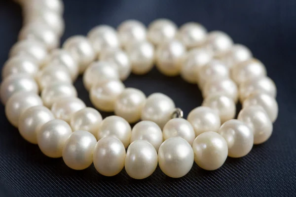 Pearl necklace over dark