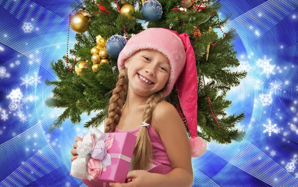 Happy Santa girl near the christmas tree