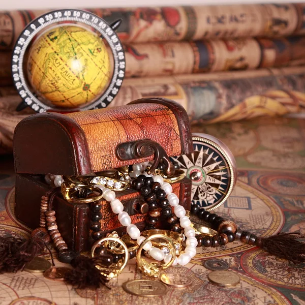 Chest with jewelry, compass, globe