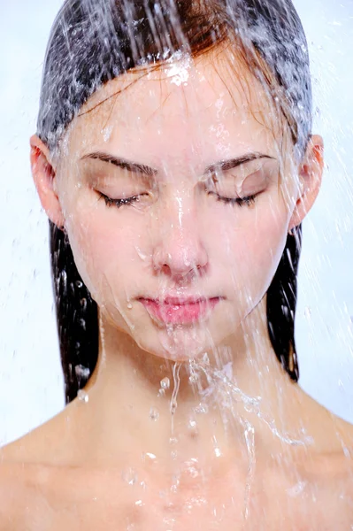 Portrait of young girl taking shower