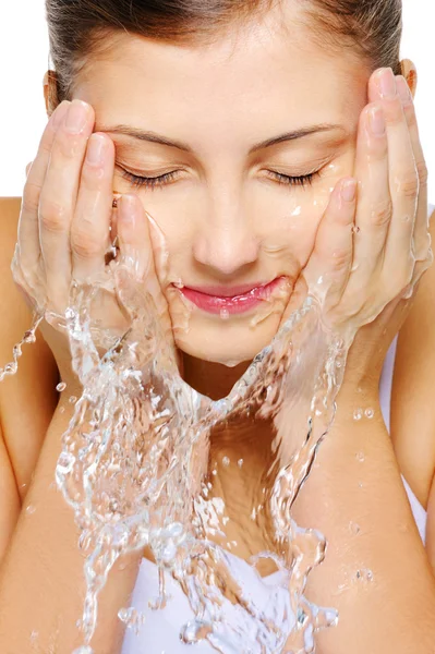 Cute woman wash her face with water