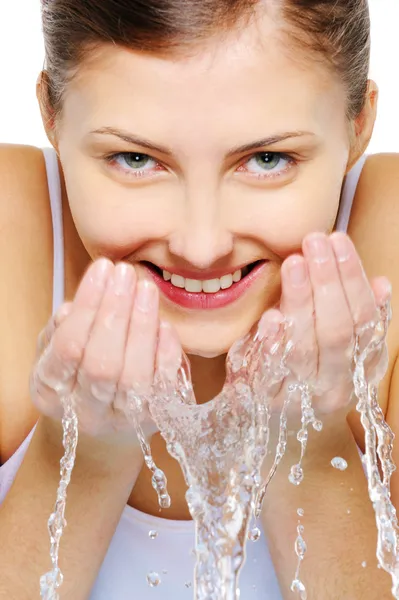 Caucasian girl washing face with water