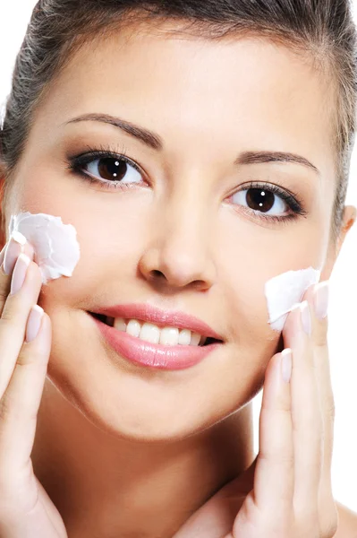 Female apply cosmetic cream